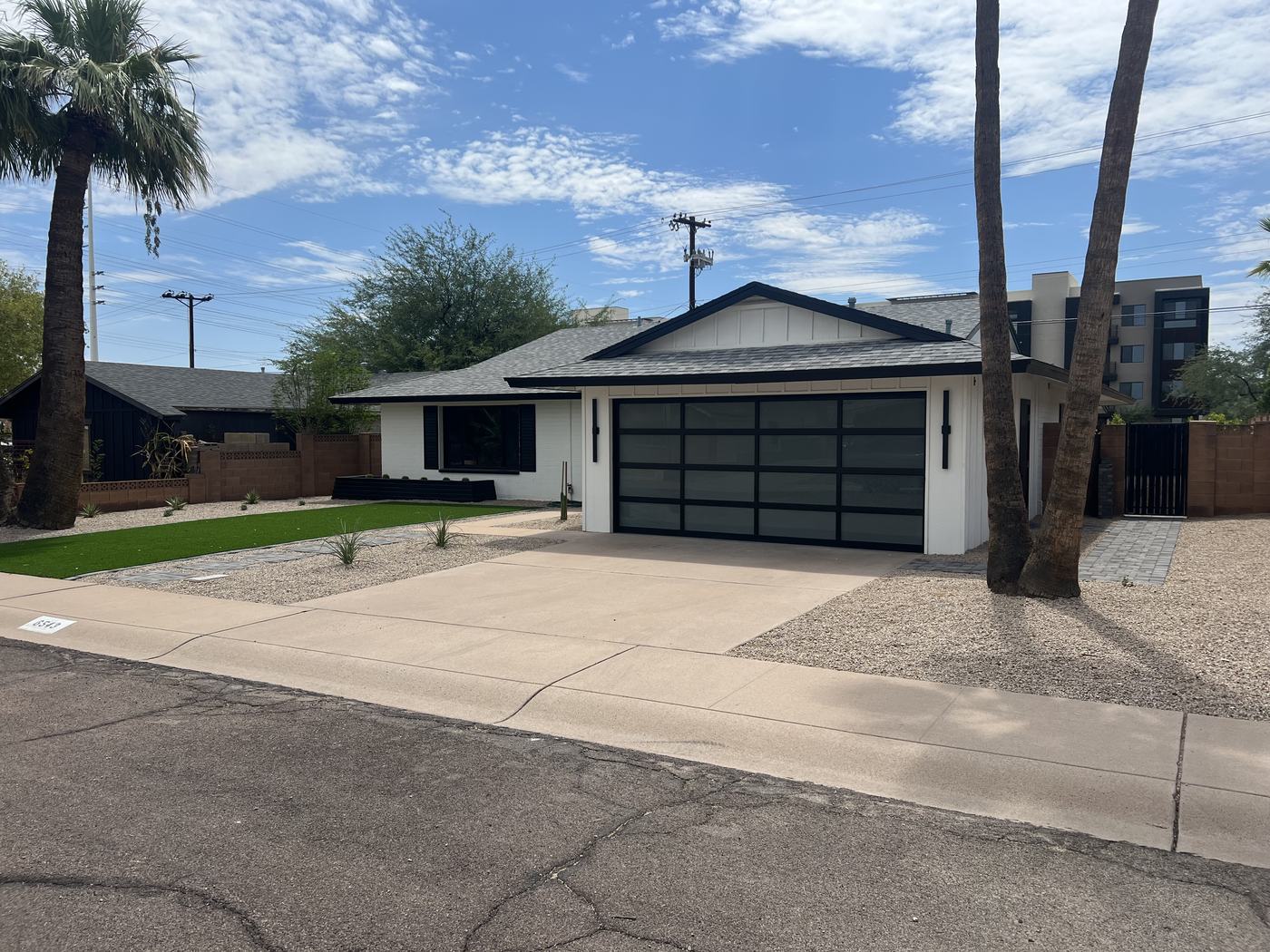 Front exterior with enclosed garage and glass-panel door