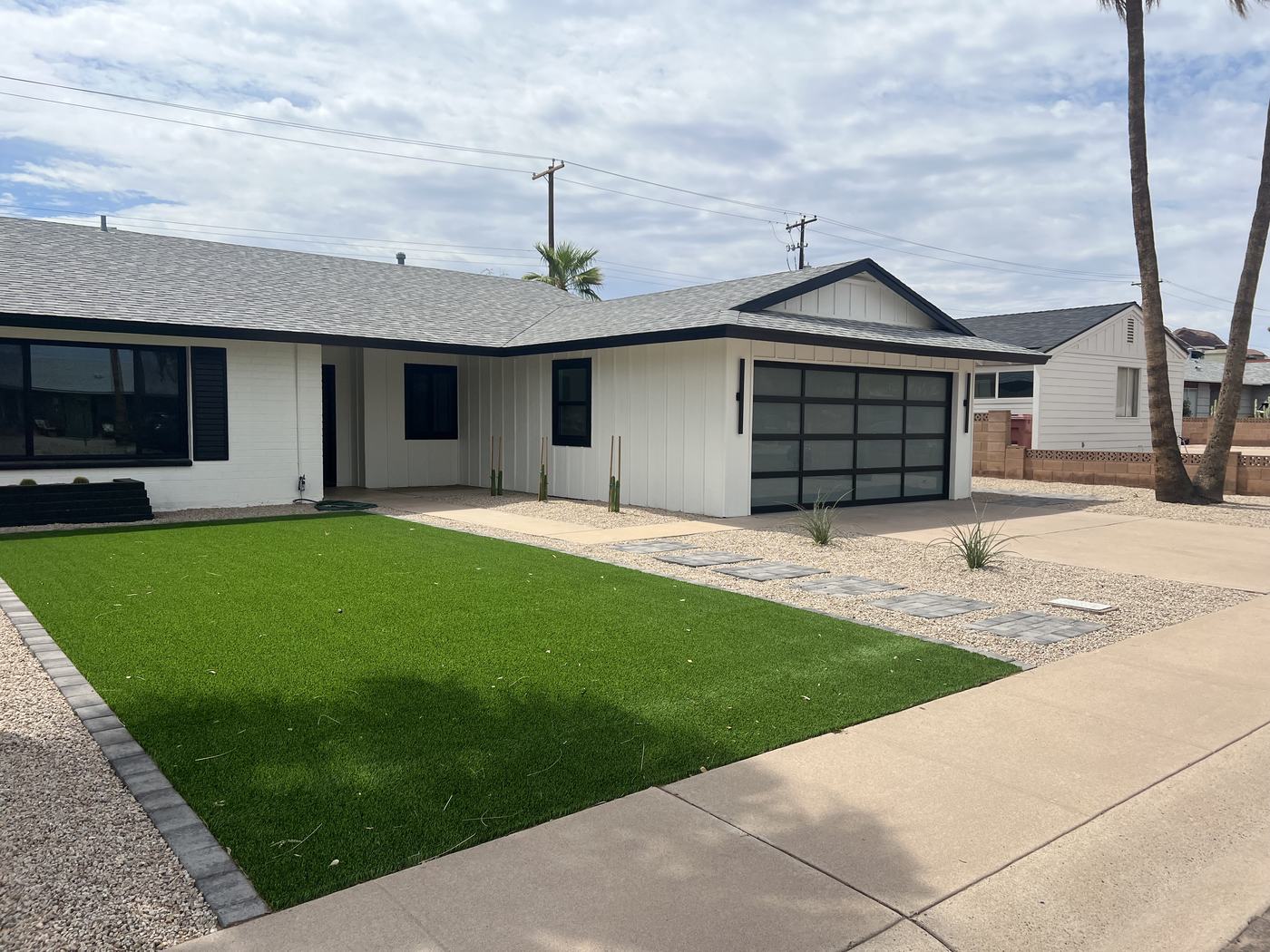 Front yard with turf and paver stepping stones