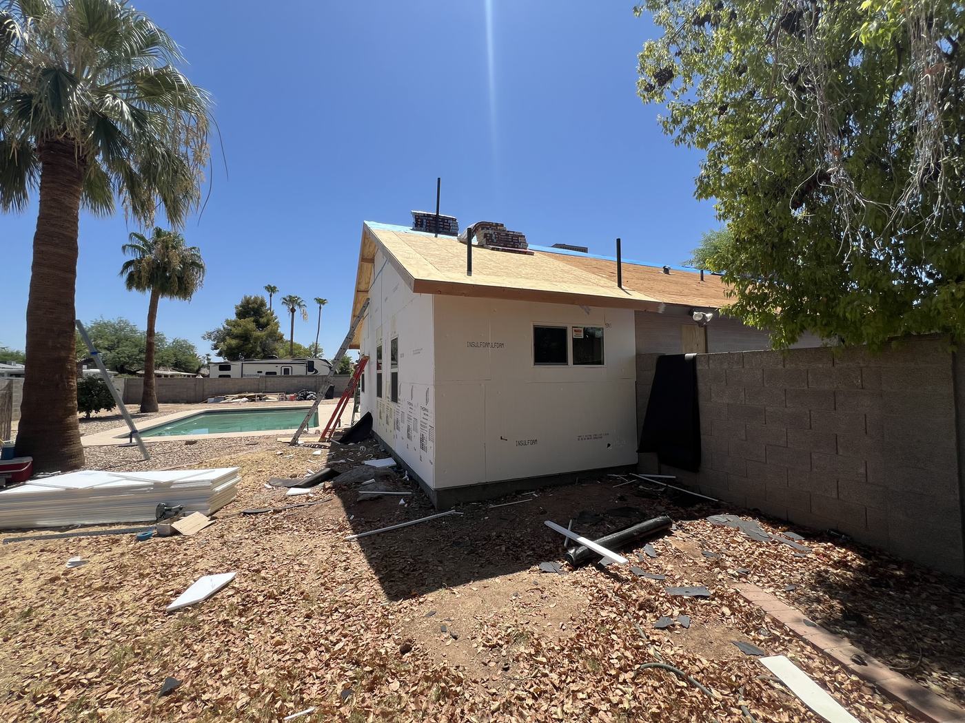 Roof sheathing carried across old and new
